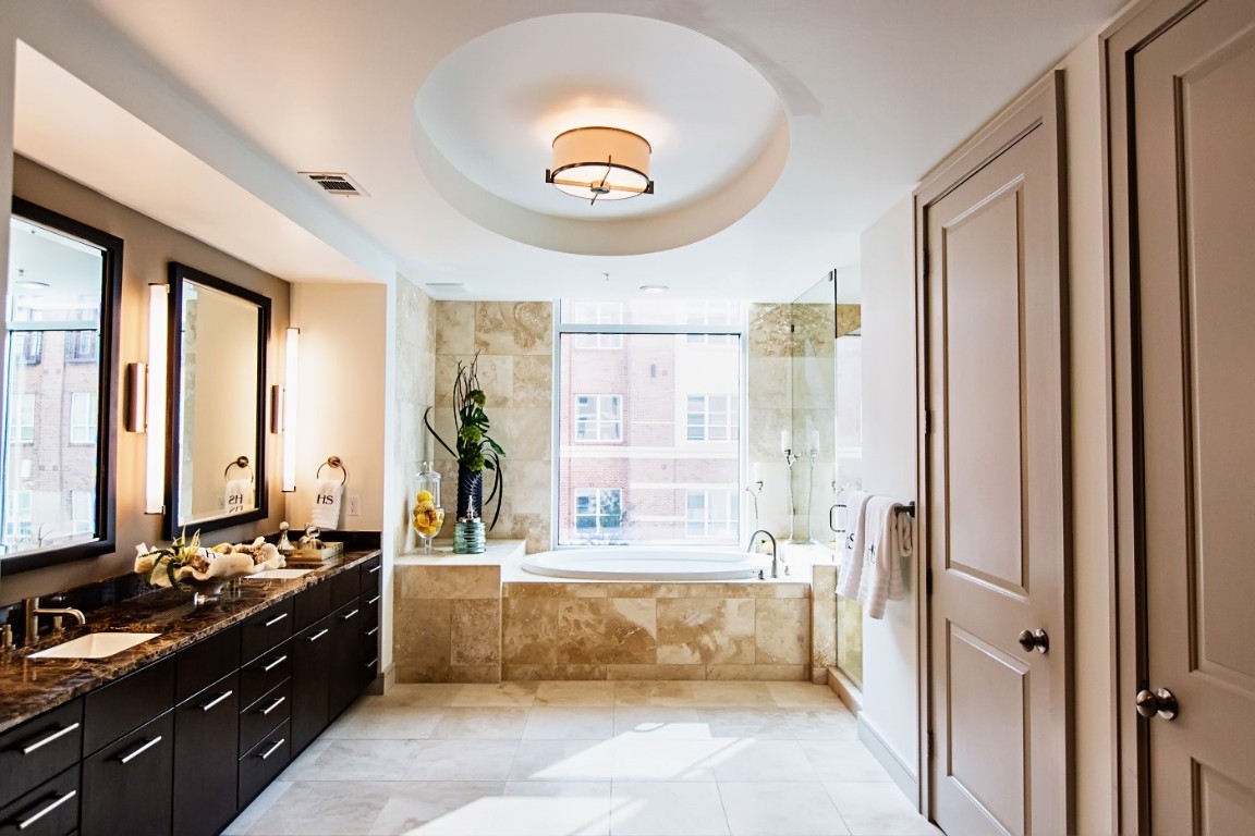5122 Morningside Drive, Unit 601 Houston, TX 77005 - Photo 6 of 7 a spacious bathroom with a double vanity sink a mirror and a bathtub