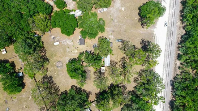 an aerial view of a house with a yard and lake view