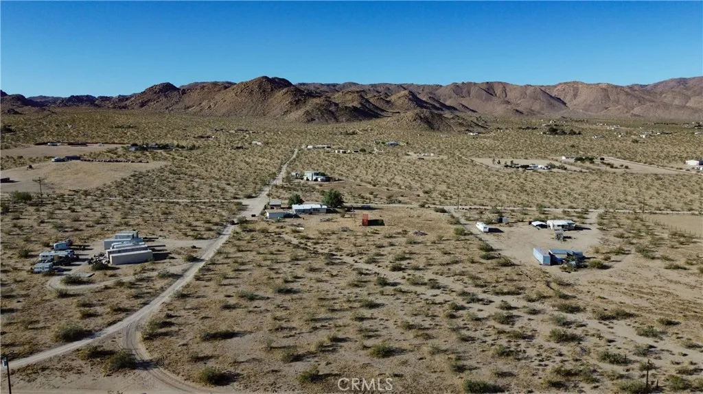 702 Bell Johnson Valley Johnson Valley, CA 92285 - Photo 11 of 12 a view of a dry yard with mountains in the background