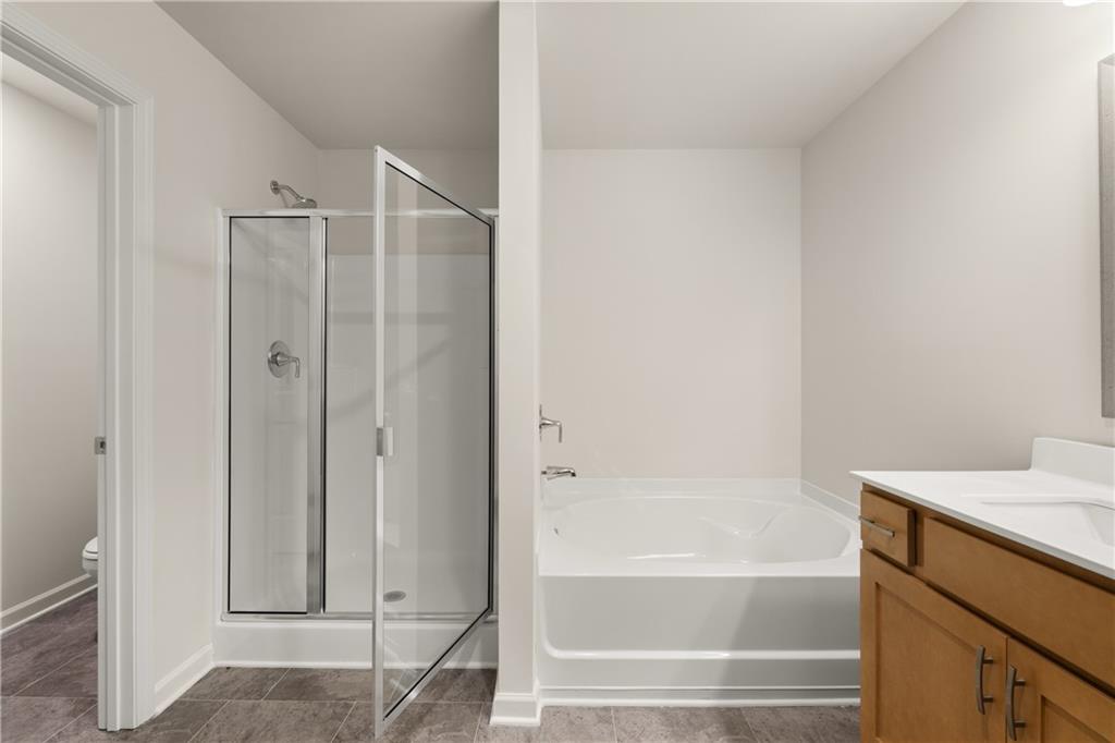 1018 Merritt Drive, Unit 10 Villa Rica, GA 30180 - Photo 18 of 20 a bathroom with a bathtub and a shower