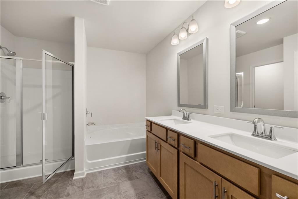 1018 Merritt Drive, Unit 10 Villa Rica, GA 30180 - Photo 19 of 20 a bathroom with a sink double vanity granite tub and shower