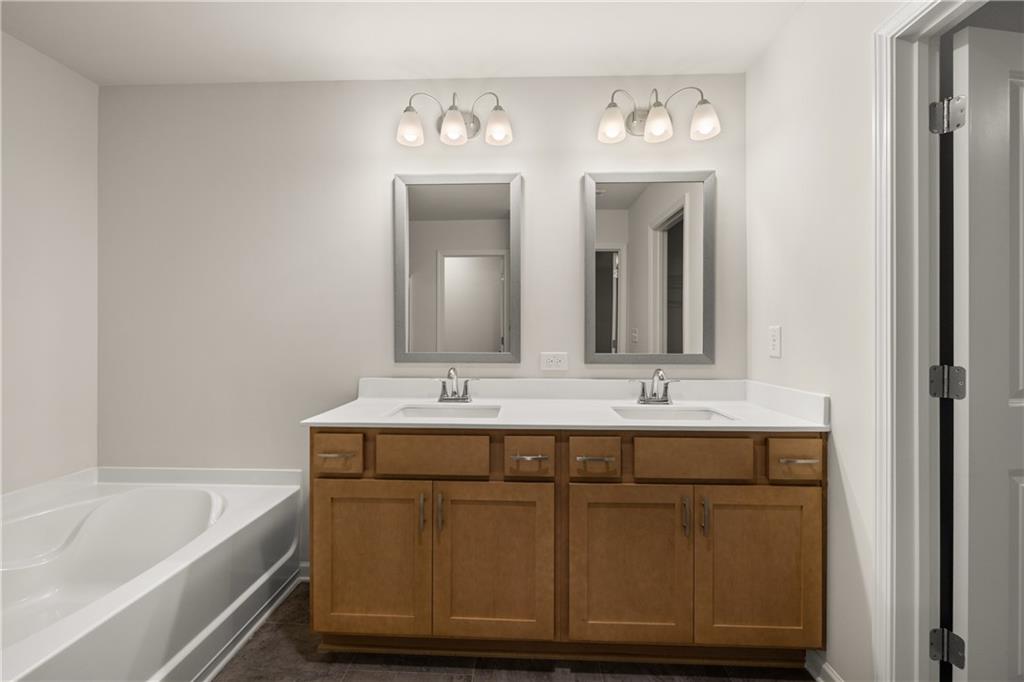 1018 Merritt Drive, Unit 10 Villa Rica, GA 30180 - Photo 20 of 20 a bathroom with a double vanity sink and a bathtub