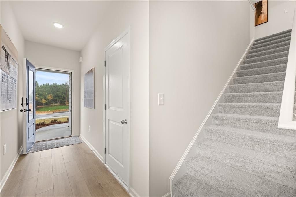 1018 Merritt Drive, Unit 10 Villa Rica, GA 30180 - Photo 3 of 20 a view of a hallway with wooden floor and windows