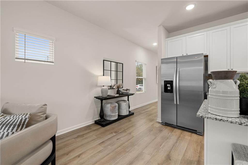 1018 Merritt Drive, Unit 10 Villa Rica, GA 30180 - Photo 9 of 20 a kitchen with stainless steel appliances wooden floor and a refrigerator