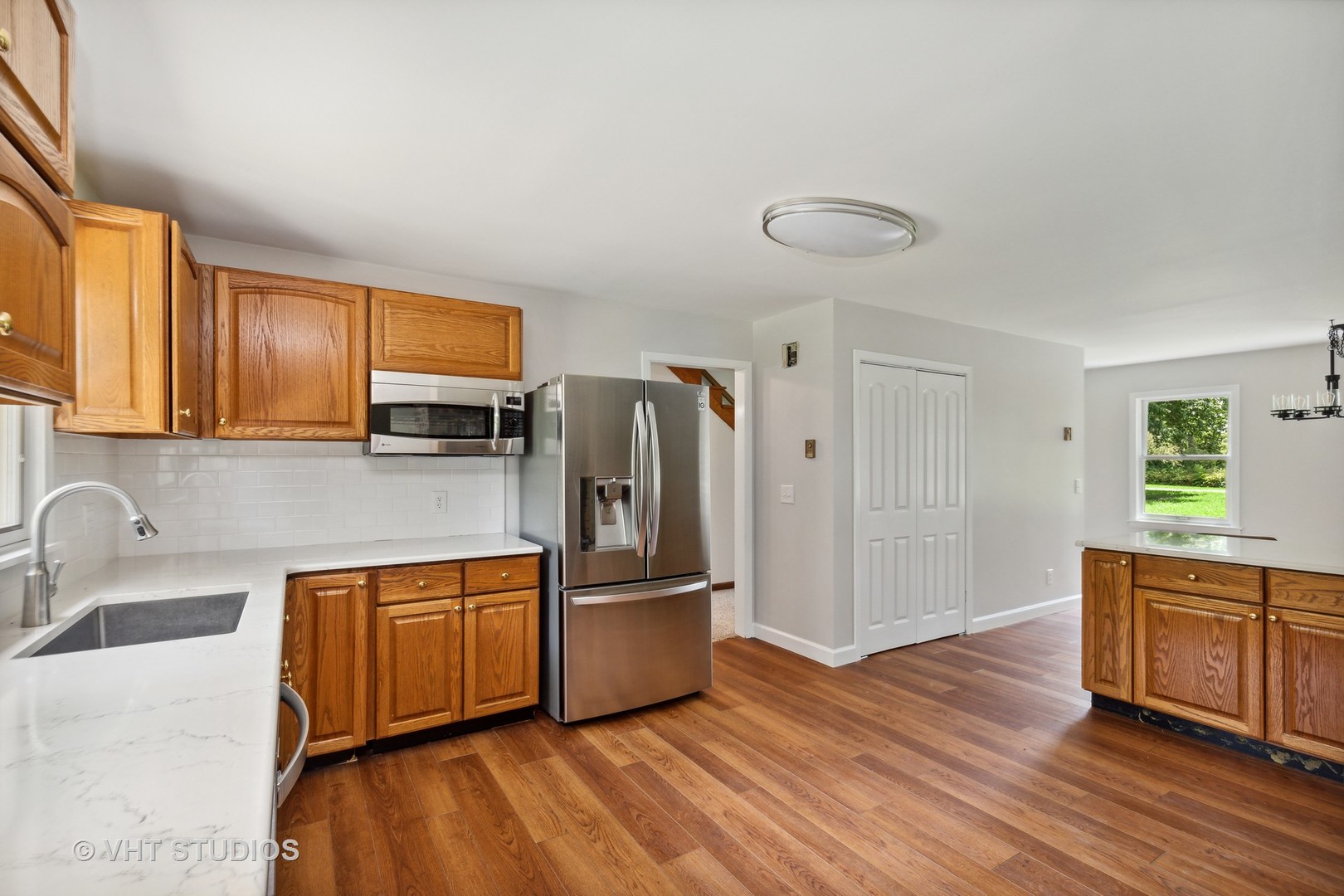 14933 Mill Road Capron, IL 61012 - Photo 4 of 15 a kitchen with stainless steel appliances granite countertop a refrigerator a sink dishwasher and wooden cabinets with wooden floor