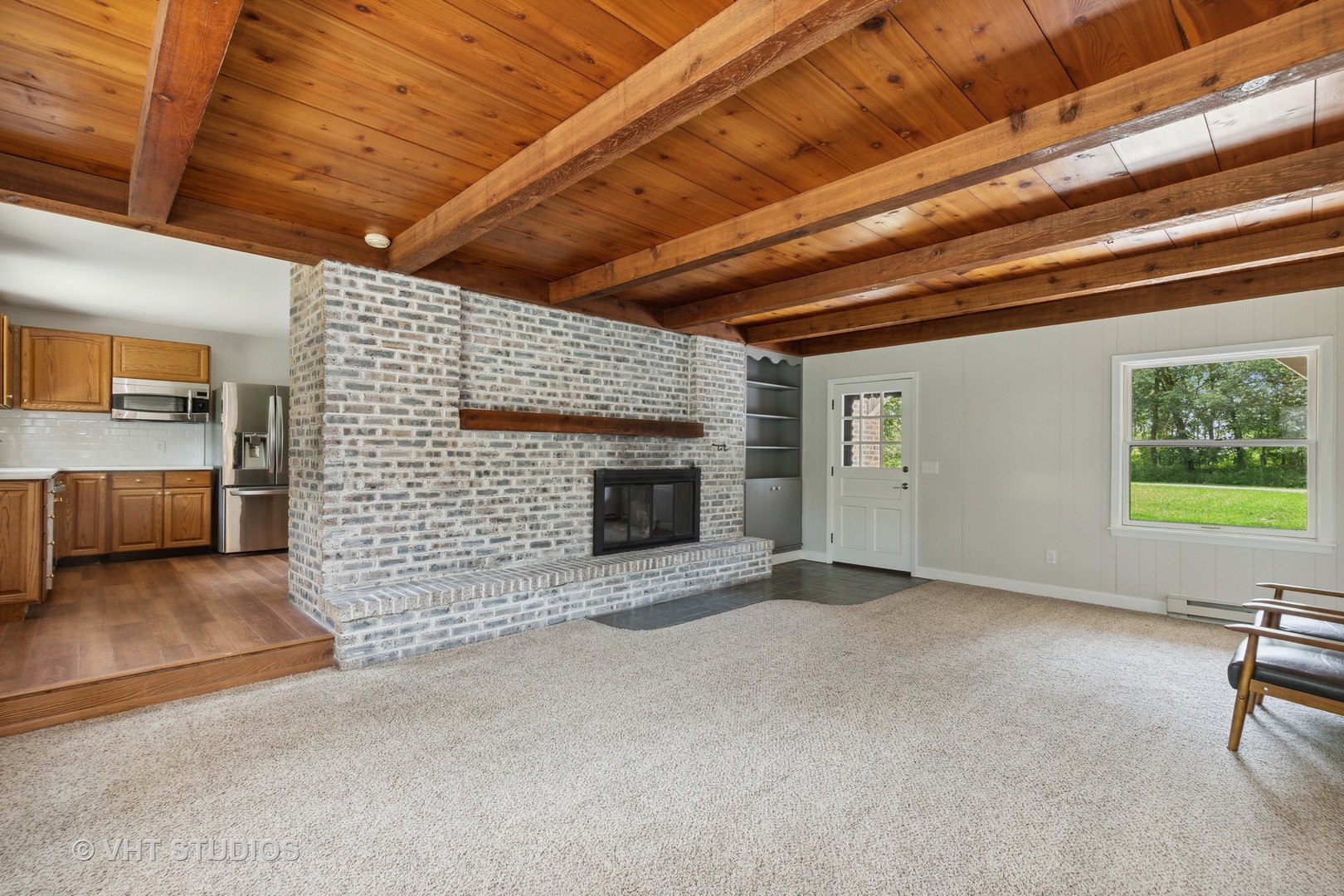 14933 Mill Road Capron, IL 61012 - Photo 6 of 15 a view of an empty room with a fireplace and a window