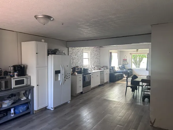 a kitchen with a refrigerator and a table