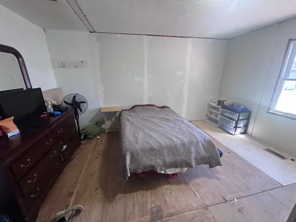 a bedroom with a bed and a desk