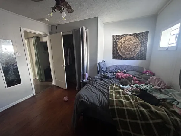 a bedroom with a bed and a mirror