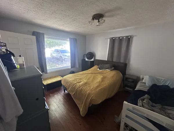 a bed sitting in a bedroom next to a window