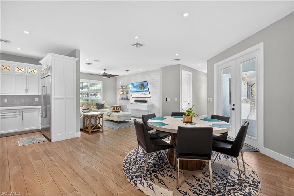 5577 Lancewood Way Naples, FL 34116 - Photo 13 of 44 a view of a dining room with furniture and wooden floor