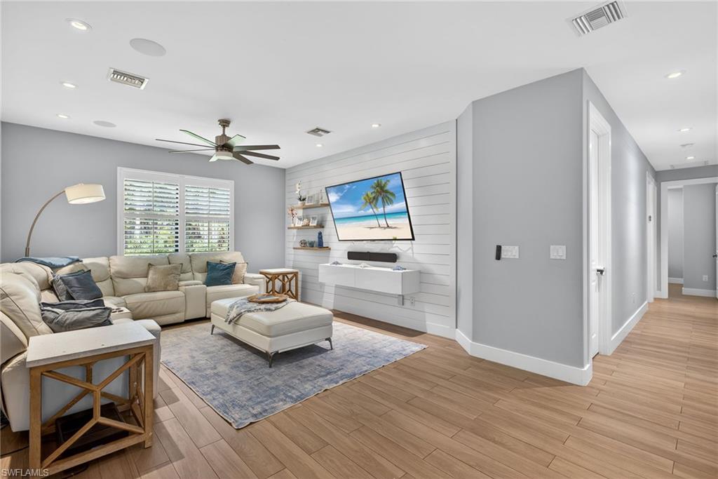 5577 Lancewood Way Naples, FL 34116 - Photo 17 of 44 a living room with furniture and wooden floor