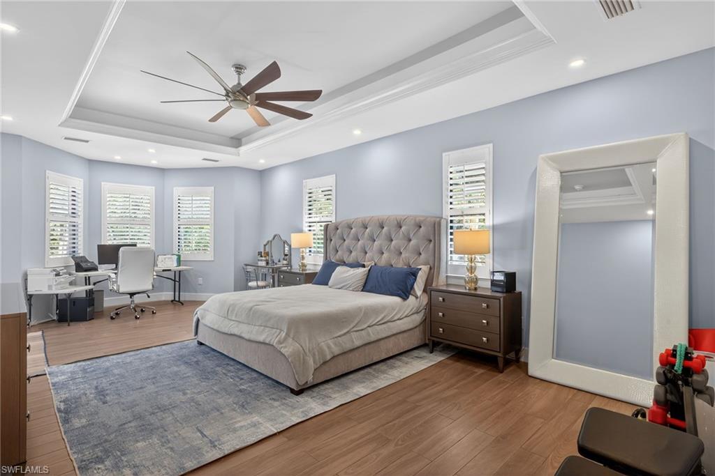 5577 Lancewood Way Naples, FL 34116 - Photo 18 of 44 a spacious bedroom with a bed and a couch