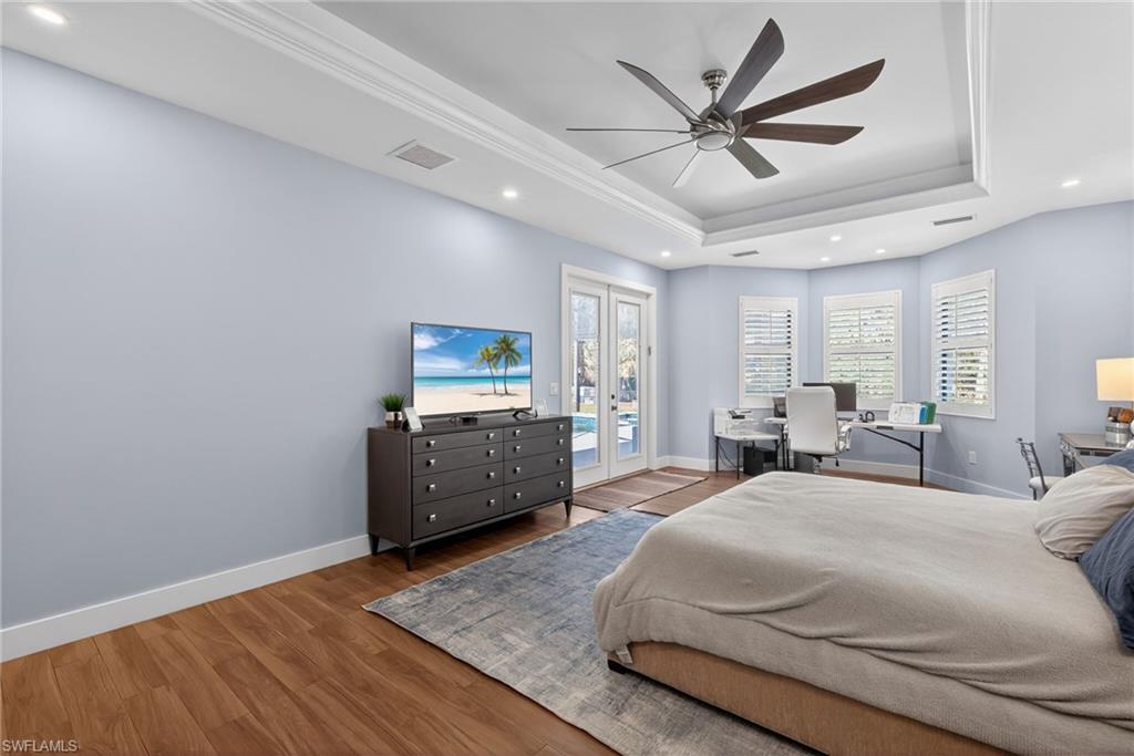 5577 Lancewood Way Naples, FL 34116 - Photo 19 of 44 a bedroom with a bed and a table