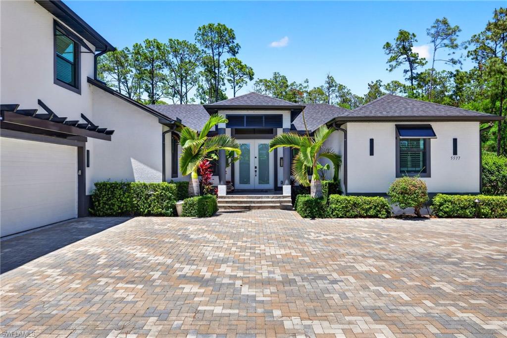 5577 Lancewood Way Naples, FL 34116 - Photo 2 of 44 a front view of a house with a porch