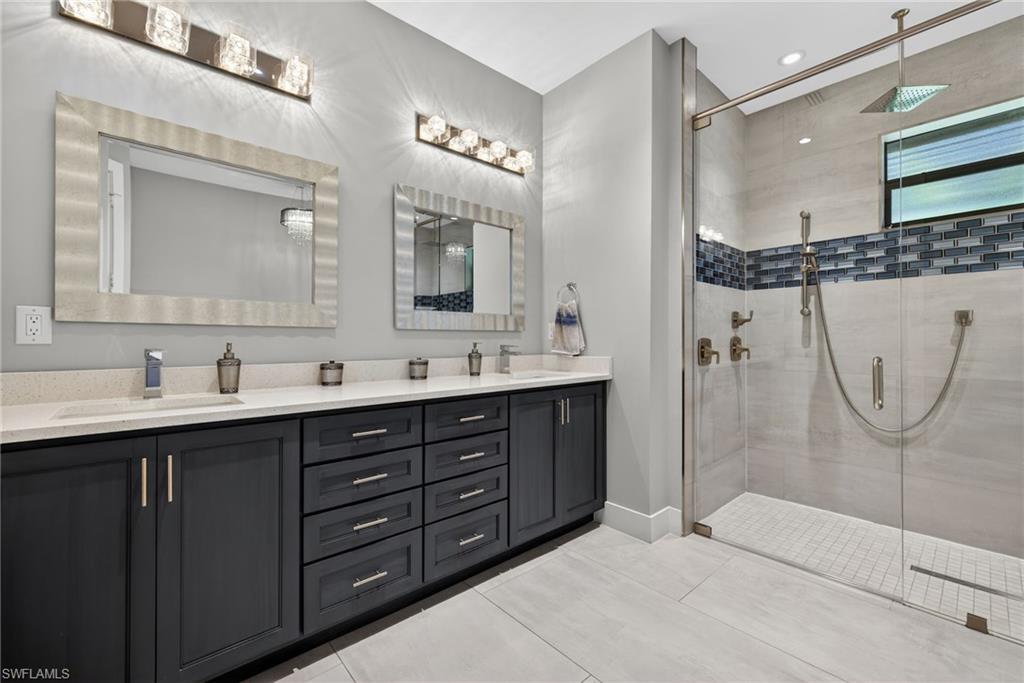 5577 Lancewood Way Naples, FL 34116 - Photo 21 of 44 a bathroom with a double vanity sink mirror and shower