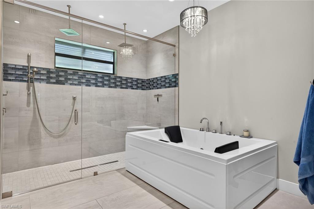 5577 Lancewood Way Naples, FL 34116 - Photo 22 of 44 a bathroom with a sink and a mirror