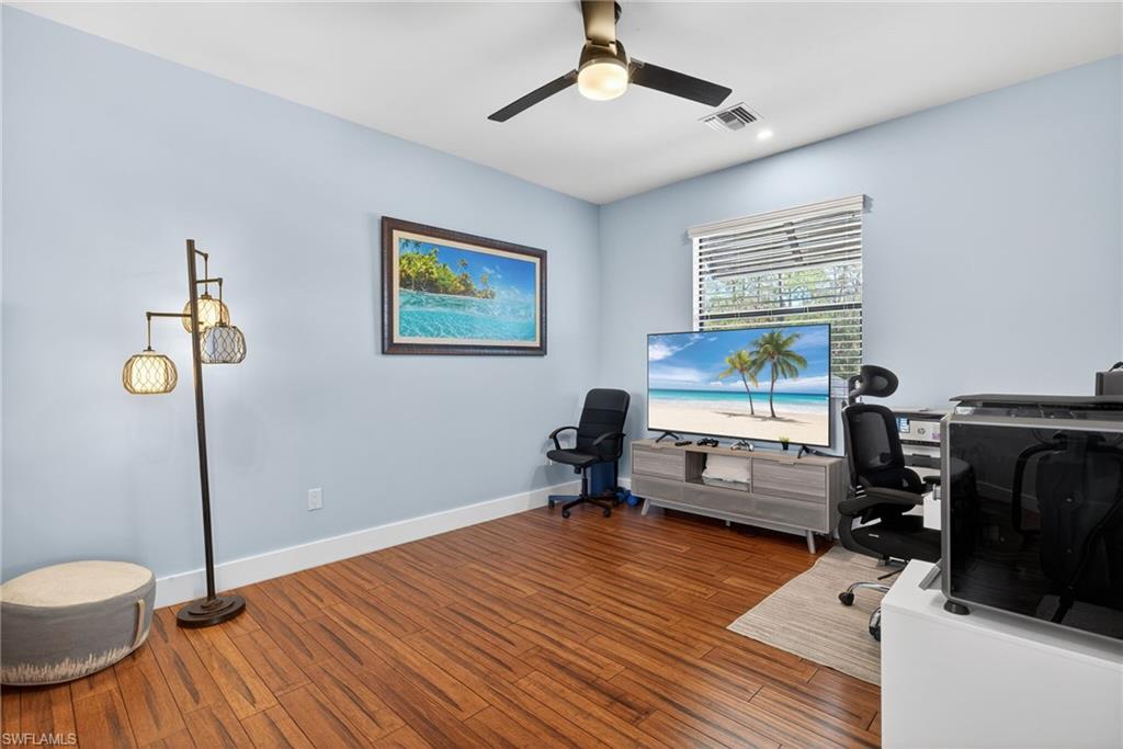 5577 Lancewood Way Naples, FL 34116 - Photo 29 of 44 a room with furniture and a wooden floor