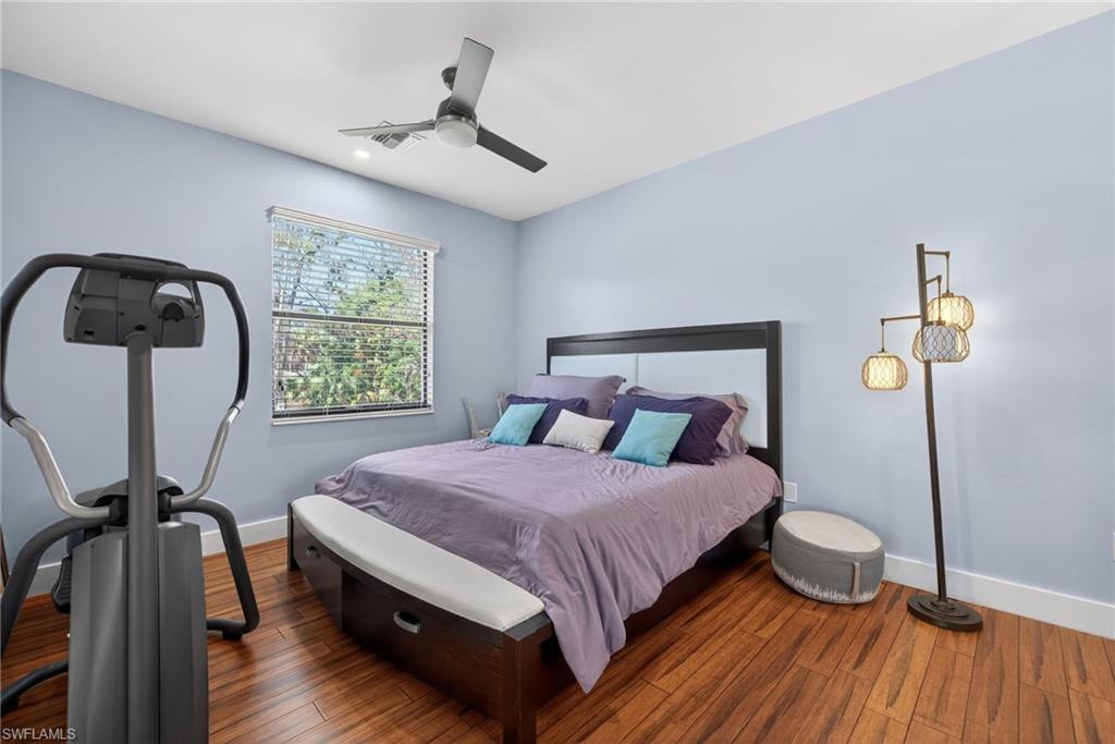 5577 Lancewood Way Naples, FL 34116 - Photo 30 of 44 a bedroom with a bed window and a table