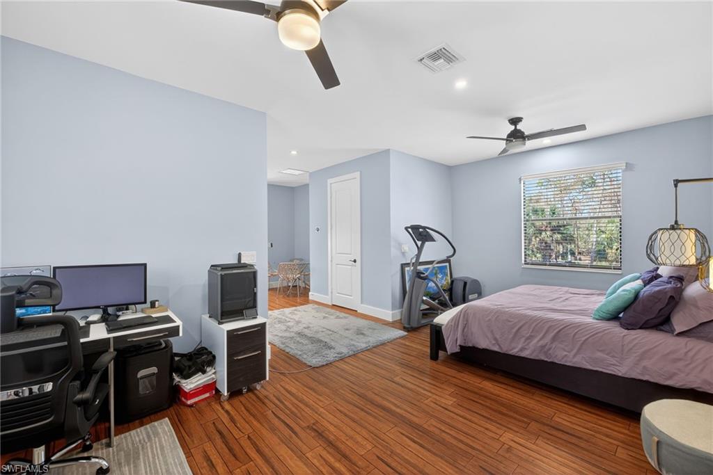 5577 Lancewood Way Naples, FL 34116 - Photo 31 of 44 a bedroom with a bed and wooden floor