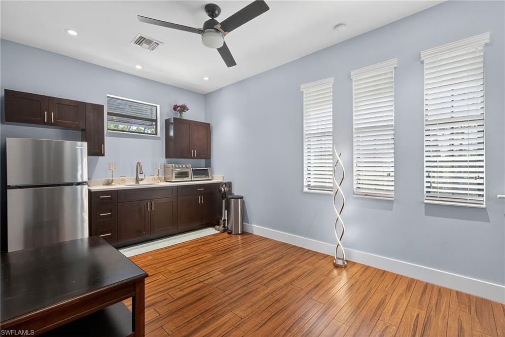5577 Lancewood Way Naples, FL 34116 - Photo 32 of 44 a kitchen with stainless steel appliances granite countertop a refrigerator and a stove top oven