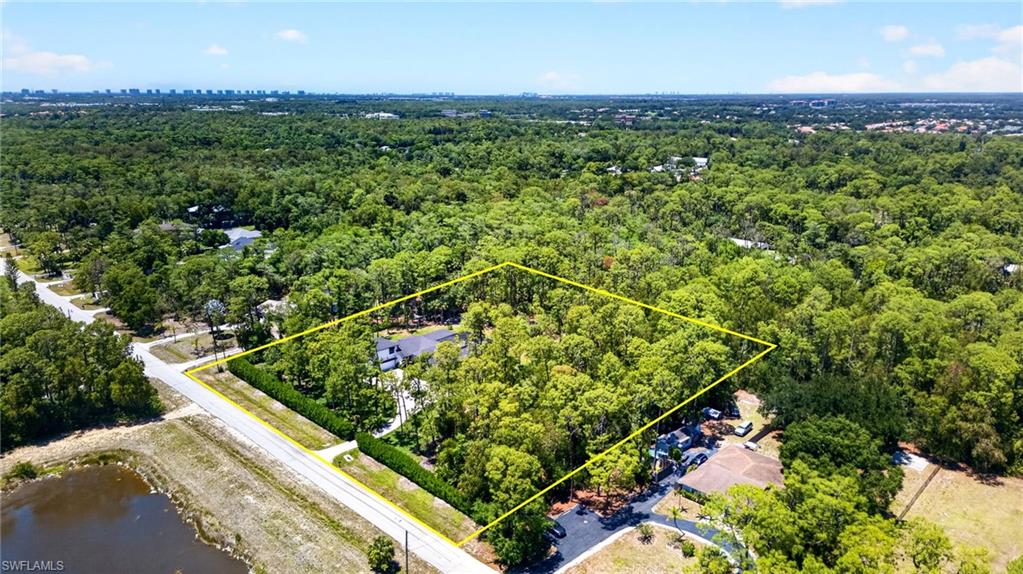 5577 Lancewood Way Naples, FL 34116 - Photo 41 of 44 an aerial view of a residential houses with outdoor space and trees