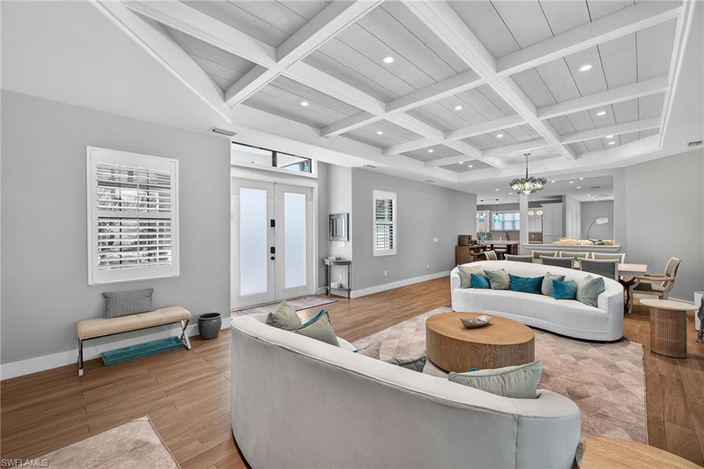 5577 Lancewood Way Naples, FL 34116 - Photo 5 of 44 a living room with furniture and wooden floor