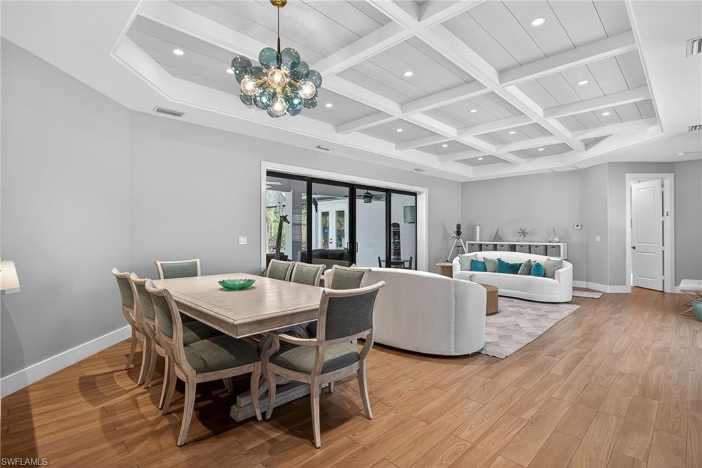 5577 Lancewood Way Naples, FL 34116 - Photo 7 of 44 a view of a dining room with furniture wooden floor and chandelier
