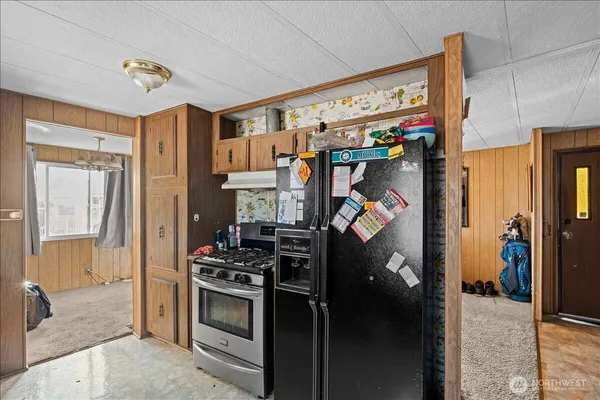 a kitchen with stainless steel appliances granite countertop a refrigerator and a stove