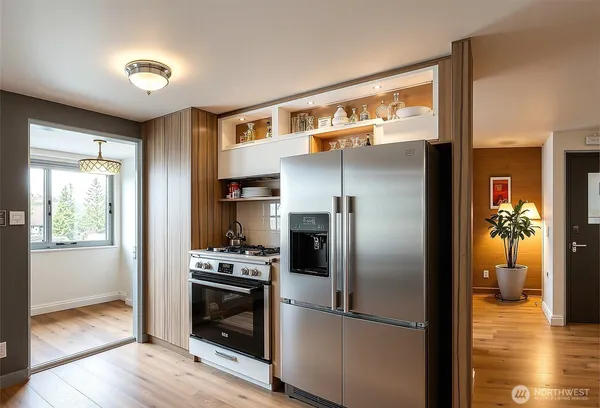 a kitchen with a refrigerator and a stove top oven