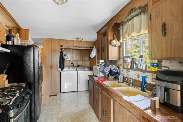 a kitchen with a sink stove and refrigerator