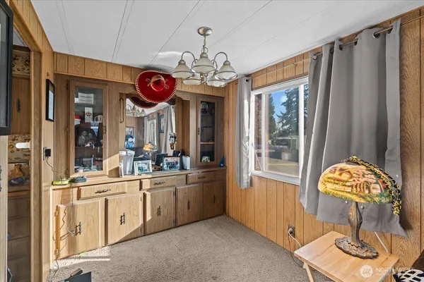 a view of a kitchen and an empty room