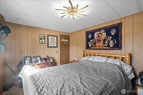 a bedroom with a bed and wall painting