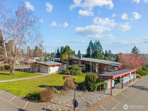 a view of a house with backyard porch and sitting area