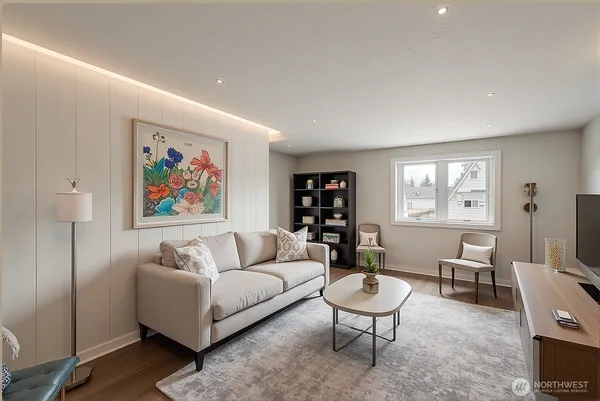 a living room with furniture a rug a table and a window