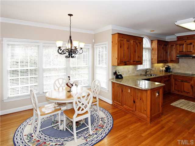 2021 Carrbridge Way Raleigh, NC 27615 - Photo 10 of 25 BREAKFAST ROOM AND KITCHEN. FABULOUS LIGHT FIXTURE, TONS OF WINDOWS, HARDWOODS. Breakfast Area