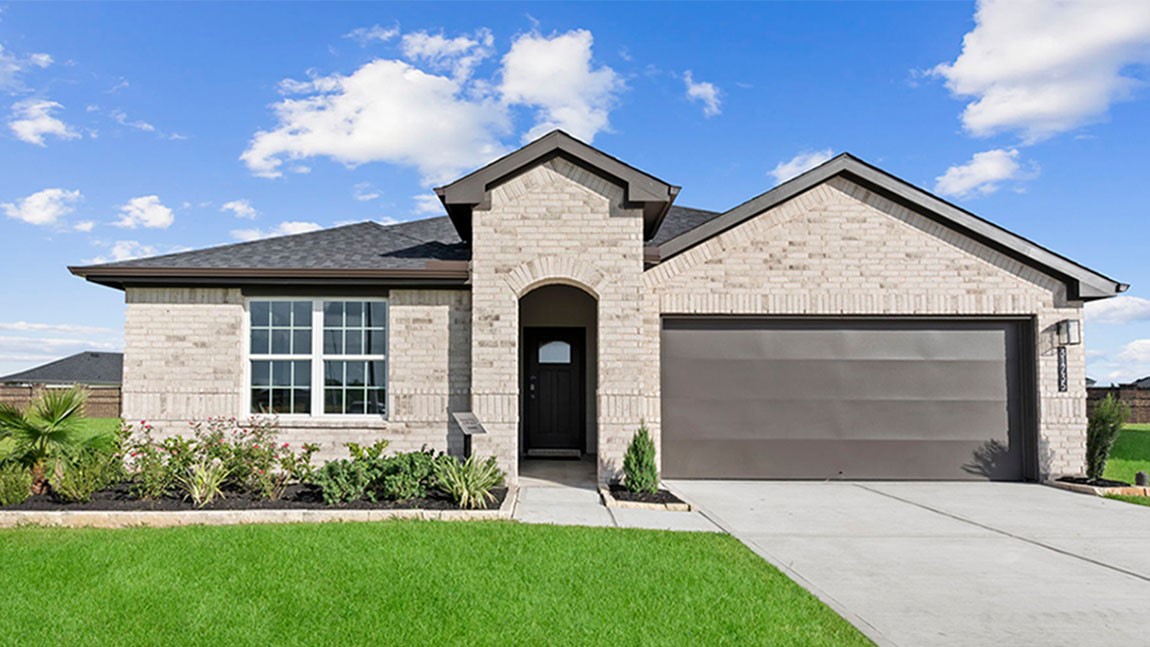 a front view of a house with a garden and garage