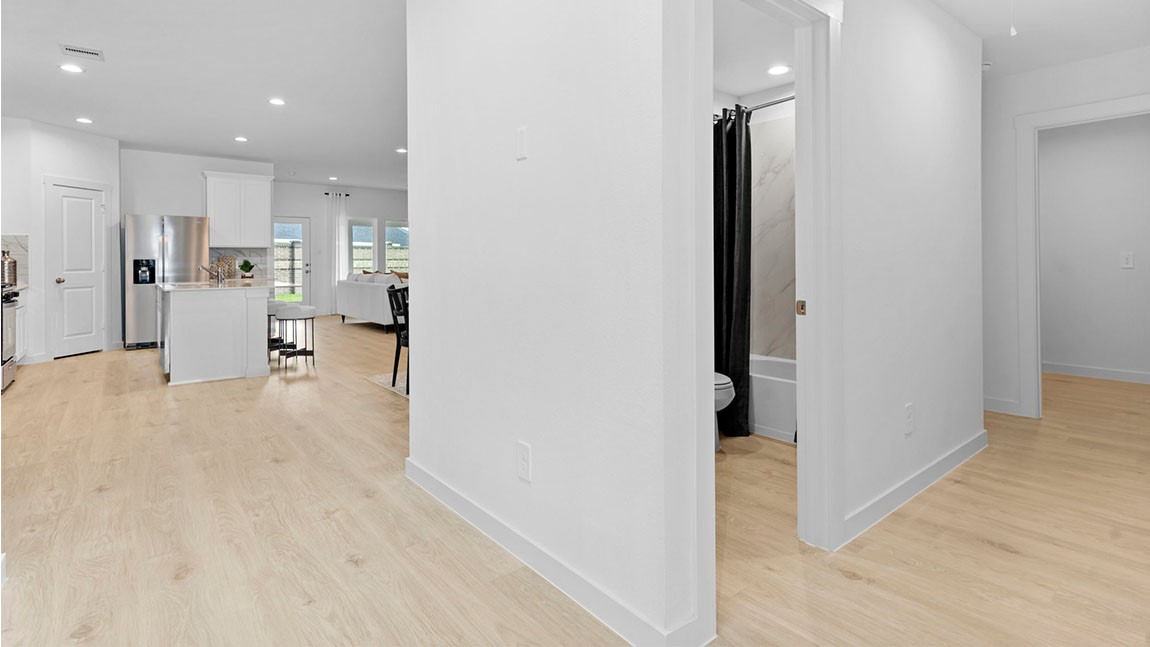 6004 Cherry Mdws Street Rosenberg, TX 77469 - Photo 12 of 39 an empty room with kitchen view and wooden floor