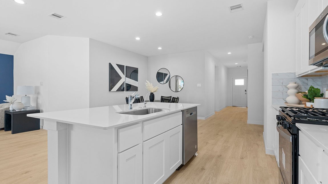 6004 Cherry Mdws Street Rosenberg, TX 77469 - Photo 5 of 39 a kitchen with a sink and stove top oven