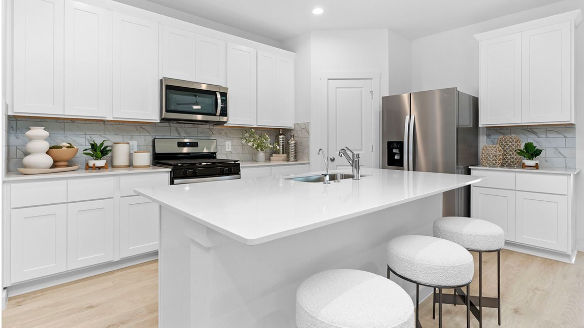 6004 Cherry Mdws Street Rosenberg, TX 77469 - Photo 9 of 39 a kitchen with stainless steel appliances a sink and a refrigerator
