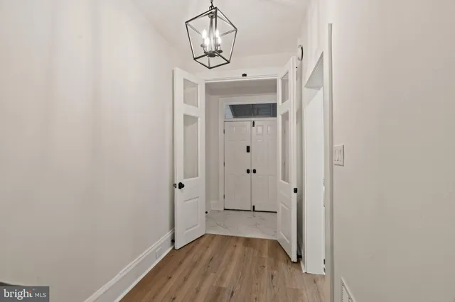 a view of a hallway with wooden floor