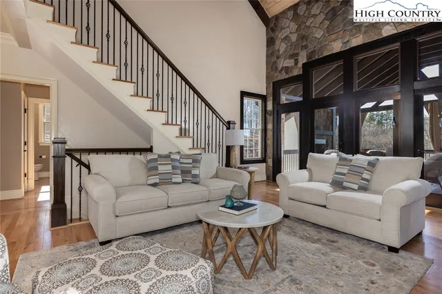 a living room with furniture and a fireplace with wooden floor