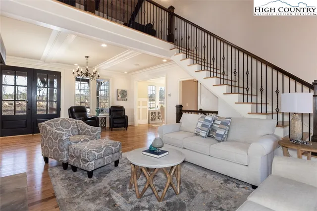 a living room with fireplace furniture and a wooden floor