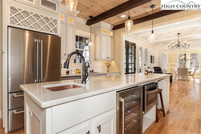 a kitchen with a sink cabinets and wooden floor