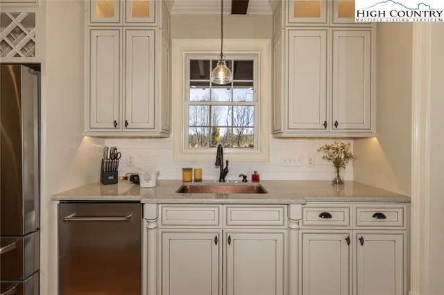 a kitchen with a sink cabinets and window