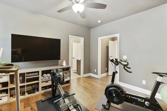 a living room with furniture a flat screen tv and a large window