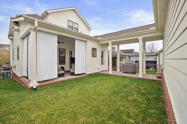 a view of a patio with a table and chairs and couches