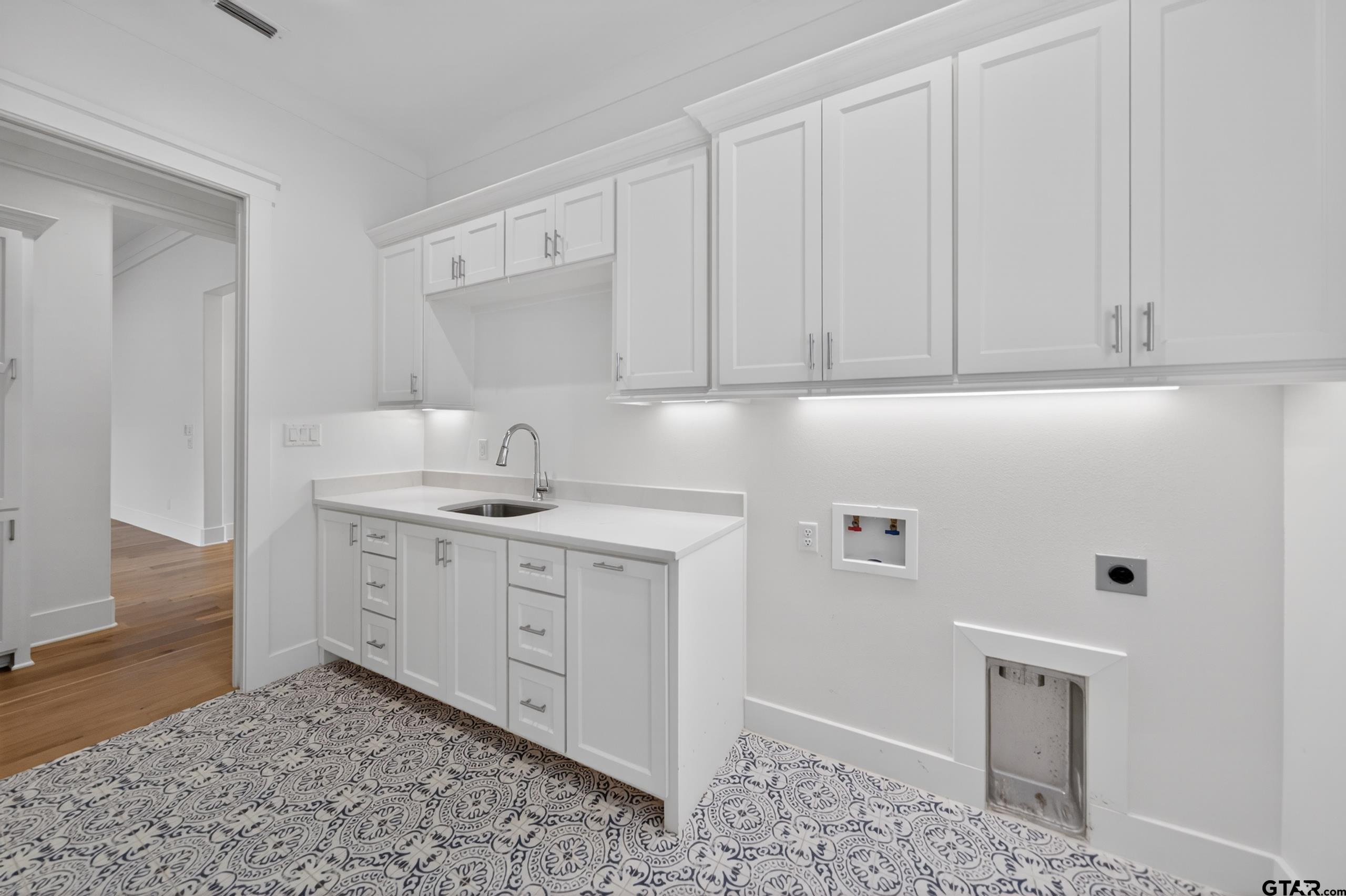 7517 Cross Gate Way Tyler, TX 75703 - Photo 41 of 47 a kitchen with granite countertop white cabinets and sink