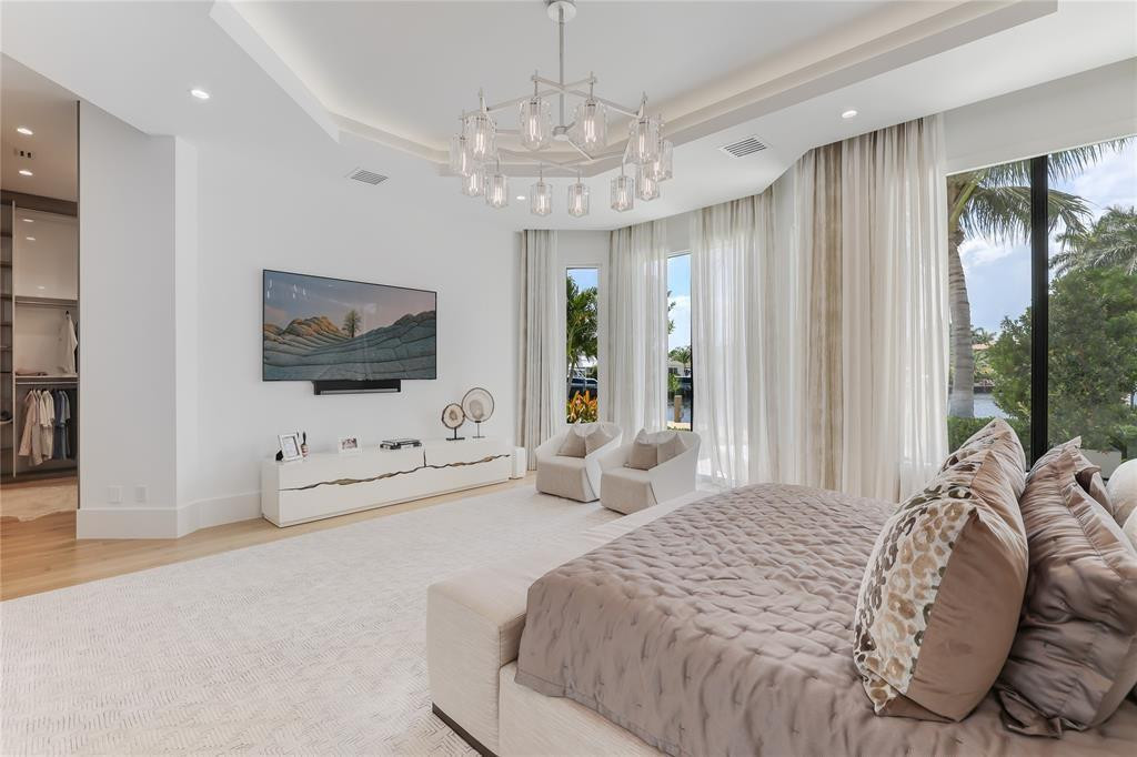 2550 Northeast 31st Court Lighthouse Point, FL 33064 - Photo 39 of 84 a spacious bedroom with a bed and a flat screen tv