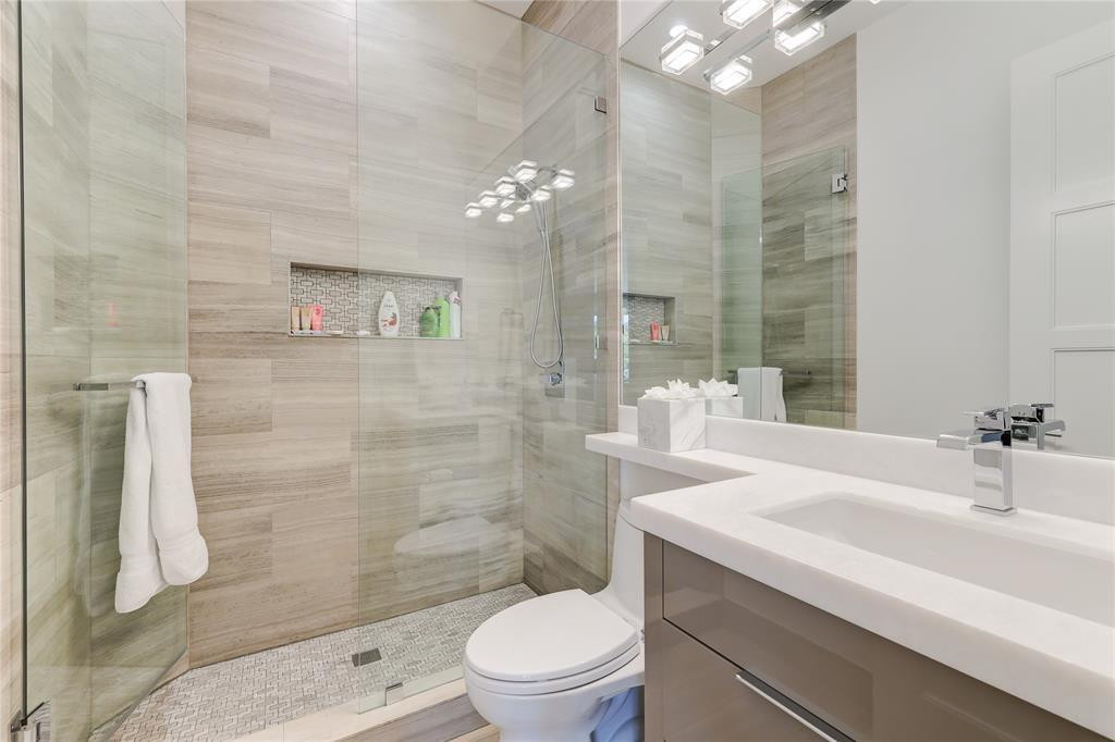 2550 Northeast 31st Court Lighthouse Point, FL 33064 - Photo 51 of 84 a bathroom with a sink a toilet a mirror and shower